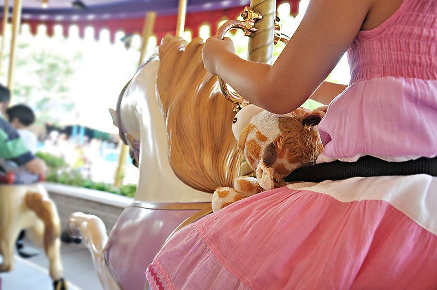 9.18, My daughter took Gerald the Giraffe for a ride on the carousel with her, making sure that he was buckled in tightly.