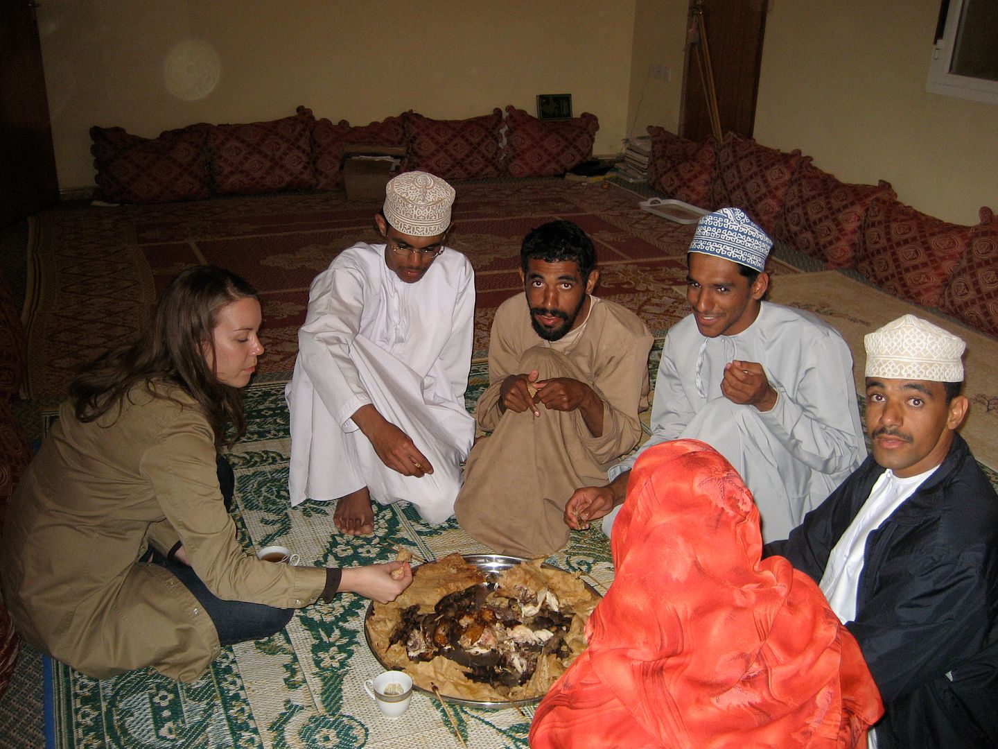 2012.01.03, Eating a traditional Omani meal of roasted lamb with a flat pancake like bread (Ibri, Oman)