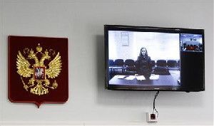 Jailed Pussy Riot punk rock group member Maria Alyokhina is seen on a monitor, as she takes part in a video conference from the penal colony, inside the courtroom during a hearing in the town of Berezniki May 22, 2013.