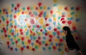 A woman walks past the Google Chicago headquarters logo in Chicago, March 20, 2012.