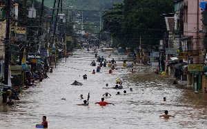 Residents wading through a flooded street in Marikina City, east of Manila, on Wednesday.
