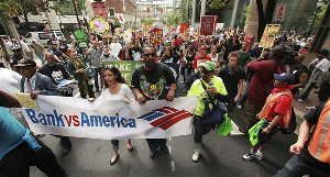 Demonstrators march on the Bank of America headquarters in in Charlotte, N.C. during a protest timed to coincide with the company's annual shareholders meeting on Wednesday.