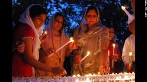 Members of Wisconsin's Sikh community conduct a candlelight vigil on Monday, August 6, for six people killed in Sunday's attack on a Sikh temple in suburban Milwaukee.