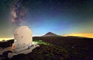 ESA's Optical Ground Station sits 2,400 meters (7,900 feet) above sea level on the volcanic island of Tenerife. Visible green laser beams are used for stabilizing the sending and receiving telescopes on the two islands. Invisible infrared single photons used for quantum teleportation are sent from La Palma, the neighboring island, and received by the 1-meter (40-inch) telescope located under the dome of the Optical Ground Station. This picture is a multiple exposure also including Tenerife's Teide volcano and the Milky Way in the background.