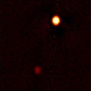 Speckle image reconstruction of Pluto and Charon obtained in visible light at 692 nanometers (red) with the Gemini North 8-meter telescope using the Differential Speckle Survey Instrument (DSSI). Resolution of the image is about 20 milliarcseconds rms (root mean square). This is the first speckle reconstructed image for Pluto and Charon from which astronomers obtained not only the separation and position angle for Charon, but also the diameters of the two bodies. North is up, east is to the left, and the image section shown here is 1.39 arcseconds across. (Credit: Gemini Observatory/NSF/NASA/AURA)