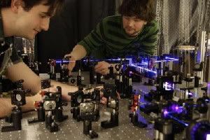 University of Toronto quantum optics graduate students Dylan Mahler (l) and Lee Rozema (r) prepare pairs of entangled photons to study the disturbance the photons experience after they are measured. The pair are part of a team that demonstrated the degree of precision that can be achieved with weak-measurement techniques, causing a re-evaulation of Heisenberg's Uncertainty Principle. (Credit: Dylan Mahler, University of Toronto)