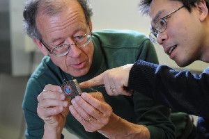Cortex communication. Engineers Arto Nurmikko and Ming Yin examine their prototype wireless, broadband neural sensing device. (Credit: Fred Field for Brown University)