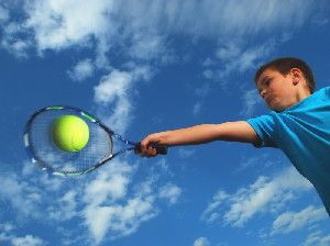 Boy swinging tennis racket (stock image). A recent study shows that different regions of the brain help to visually locate objects relative to one's own body and those relative to external visual landmarks.