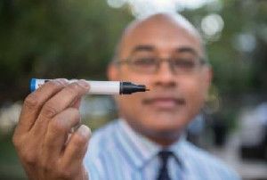 Jayant Pinto, M.D., is shown with one of the Sniffin' Sticks used to test a patient's ability to identify scents for his research on olfactory dysfunction and aging.