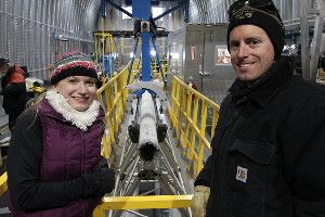 Kristina Slawny (left) and Jay Johnson (right) stand next to the Deep Ice Sheet Coring Drill, designed and managed by the Ice Drilling Design and Operations group at the University of Wisconsin-Madison.
