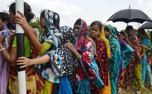 Associated Press/Ismail Ferdous - Bangladeshi garment workers employed at Rana Plaza, the garment factory building that collapsed, stand in a queue to receive wages in Savar near Dhaka, Bangladesh, Wednesday