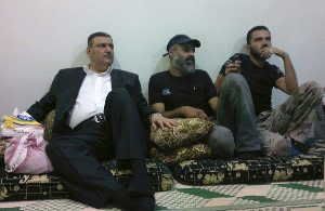  Defected Syrian Prime Minister Riyad Hijab (L) sits with members of the Free Syrian Army in Deraa August 7, 2012.