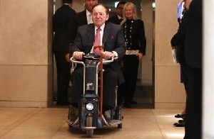 Las Vegas Sands Corp Chairman and CEO Adelson rides his wheelchair after a news conference in Tokyo