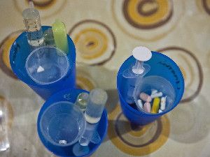 Daily medications for young children with HIV include both tablets and liquid drugs in syringes.