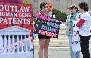 Protesters hold banners demanding a ban on the patenting of human genes outside the Supreme Court in Washington. (Mladen Antonov / AFP/Getty Images / April 15, 2013)