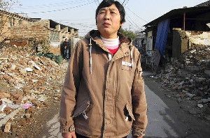  Liu Siping, a 50-year-old migrant, lives in a semi-demolished neighborhood on the outskirts of Beijing. Her rural residency permit, or hukou, limits her access to jobs and social services in cities. (Tessa Pierson / Los Angeles Times / December 12, 2012)
