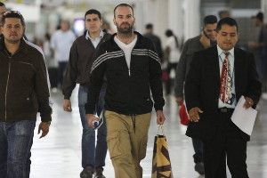 A handout photo provided by Venezuela's Ministry of Interior and Justice shows American filmmaker Tim Tracy, center, Wednesday as he is being expelled from Caracas, Venezuela. (Ministry of Interior and Justice / European Pressphoto Agency / June 5, 2013)