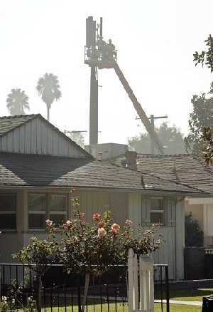  Workers finish a cellphone tower in Sherman Oaks that drew neighbors' protests. The City Council is studying tighter requirements on placing wireless transmitters on utility poles. (Al Seib / Los Angeles Times / November 17, 2010)