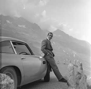 Sean Connery leans on an Aston Martin DB5 while taking a break from shooting 'Goldfinger' in the Swiss Alps. (Click to enlarge.)