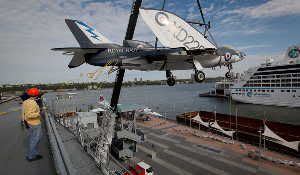 A British Royal Navy fighter-bomber known as a Supermarine Scimitar F1 was among three aircraft lifted by crane over the side of the aircraft carrier Intrepid on Wednesday.