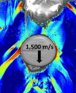 A nanosized glass bead traveling 1.5 kilometers per second is halted by a polyurethanelike material, seen here in cross-section. Red indicates locations where the material has been most compressed on impact.