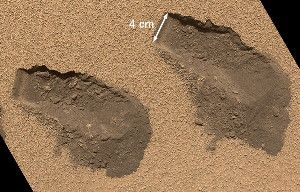 The Curiosity rover collected samples of Martian soil (trenches made by the rover's scoop shown) to complete its first chemical analysis of the Red Planet's surface.