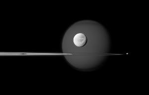 Saturn's varied moons-including Titan (background), Dione (center) and Pandora (right) may have resulted from violent collisions in the early Saturnian system.