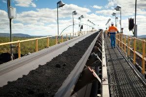 Coal moves by conveyer belt at Coppabella mine, about 470 miles (760 kilometers) northwest of Brisbane, Australia. With a new climate and energy law in place, Australia is seeking to lower its carbon emissions.
