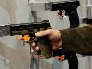 A convention attendee tries out a handgun on display at the Smith & Wesson booth at the National Shooting Sports Foundation's Shooting, Hunting and Outdoor Trade Show in Las Vegas.(Photo: Ethan Miller, Getty Images)