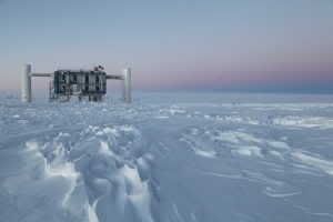 The IceCube Lab in the setting sun at the Amundsen-Scott South Pole Station in Antarctica inlate March, 2012. IceCube uses a cubic kilometer of ice to house over 5,000 optical modulesthat are connected via cable to the lab. (Photo: NSF/S. Lidstrom)
