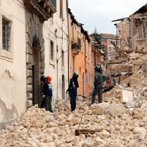 SEISMIC TRIAL OF THE CENTURY: Emergency personnel inspect damaged buildings following the April 2009 earthquake in central Italy.