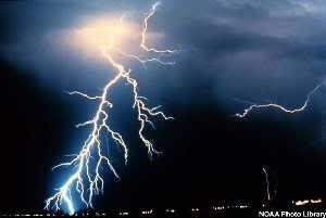 Multiple cloud-to-cloud and cloud-to-ground lightning strokes during a night-time thunderstorm.