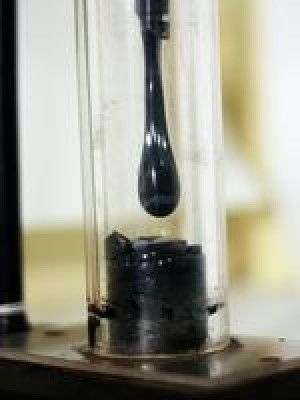 A droplet of tar pitch hangs before falling from a funnel into a jar. Photograph courtesy Shane Bergin