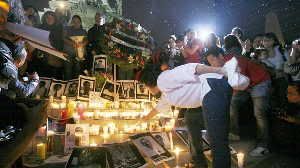 A woman lights a candle during a tribute to slain Mexican journalists at the Monument of Independence in Mexico City on May 5. The vigil took place to protest violence against the press after the brutal murders of four journalists in Veracruz state.