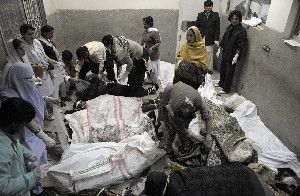 Rescue teams attend the bodies of victims who died in a marketplace bomb blast in Quetta, Pakistan, on Saturday.