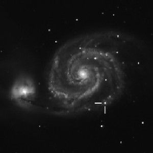 SPOTTED SWIRL: Perpendicular lines indicate the position of the 2011 supernova in this image of the Whirlpool Galaxy.