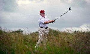 Donald Trump plays a stroke as he officially opens his new Trump International Golf Links course in Aberdeenshire, Scotland, last July. Now, he is aggressively fighting Scottish plans to build 11 wind turbines off the coast overlooked by his golf course and other proposed projects.